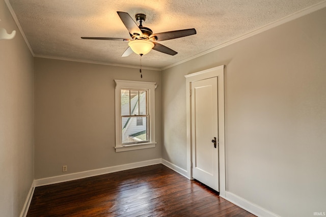 spare room with dark wood-type flooring, a textured ceiling, ceiling fan, and baseboards