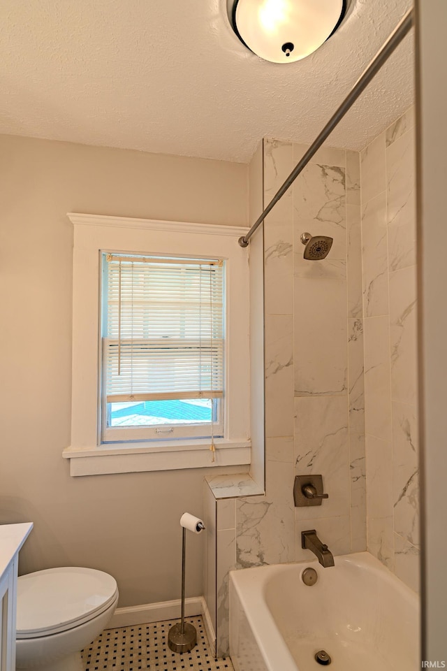 bathroom featuring vanity, toilet, shower / tub combination, and a textured ceiling
