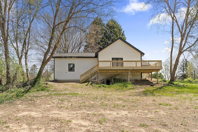 back of property featuring a deck and stairway