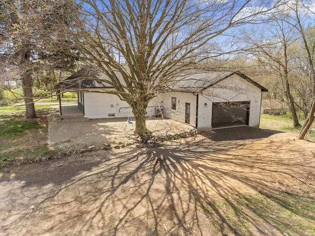 view of front of property with a detached garage