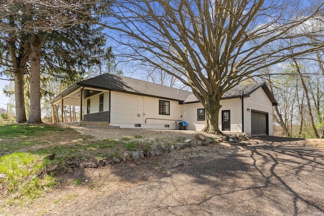 view of front of home featuring driveway and a garage