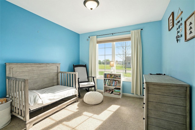 bedroom with baseboards and carpet