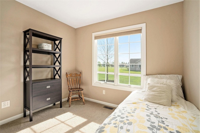 carpeted bedroom featuring baseboards and visible vents