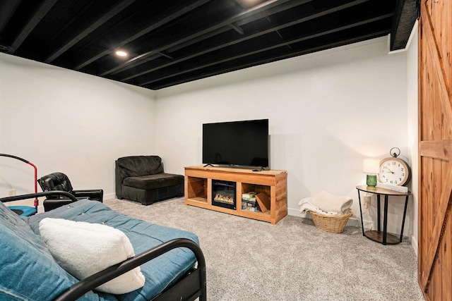 living area with baseboards and carpet