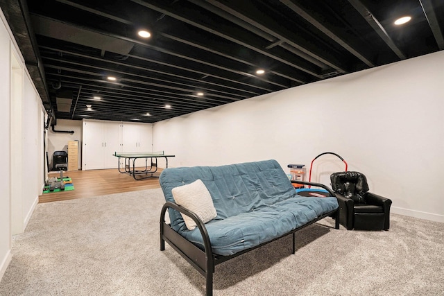 sitting room with baseboards and carpet