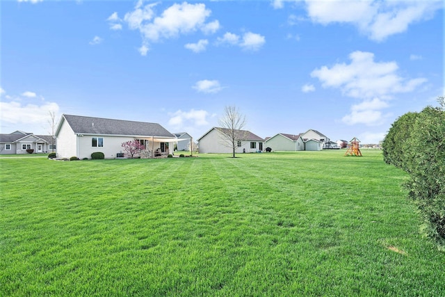 view of yard with a playground and a residential view