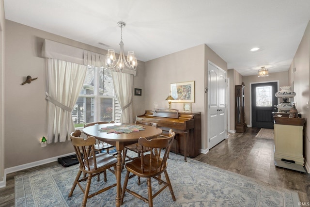 dining space featuring visible vents, wood finished floors, baseboards, recessed lighting, and a chandelier