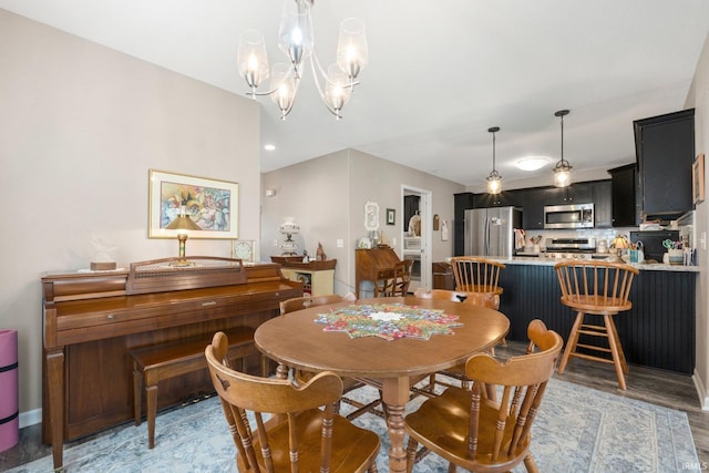dining space featuring an inviting chandelier and light wood finished floors