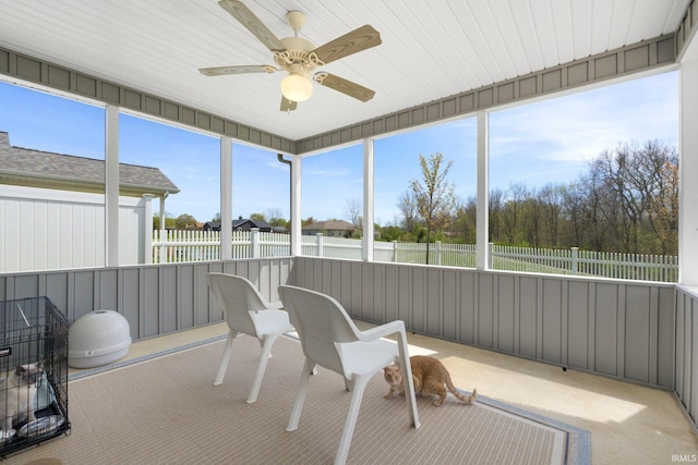 sunroom / solarium featuring ceiling fan