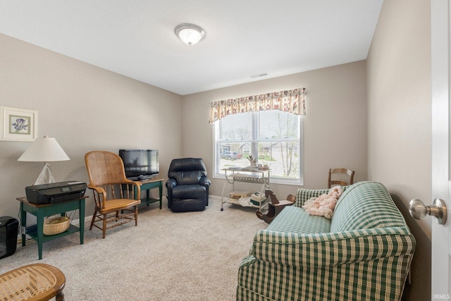 sitting room featuring visible vents, carpet flooring, and baseboards