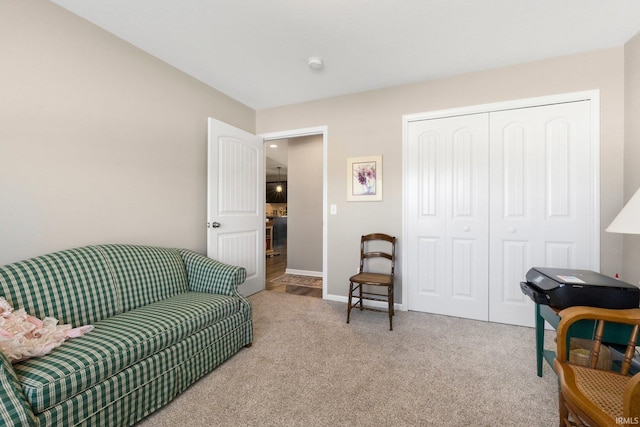 sitting room featuring carpet floors and baseboards