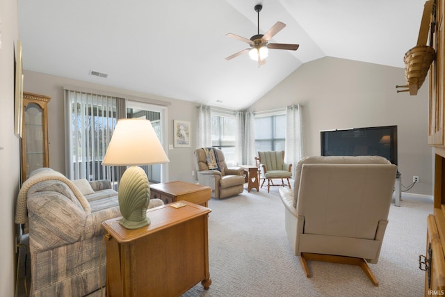 living room with visible vents, ceiling fan, vaulted ceiling, and light colored carpet