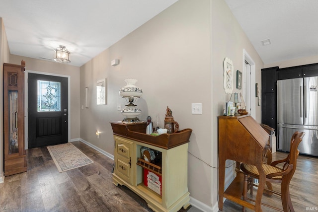 entryway featuring baseboards and wood finished floors
