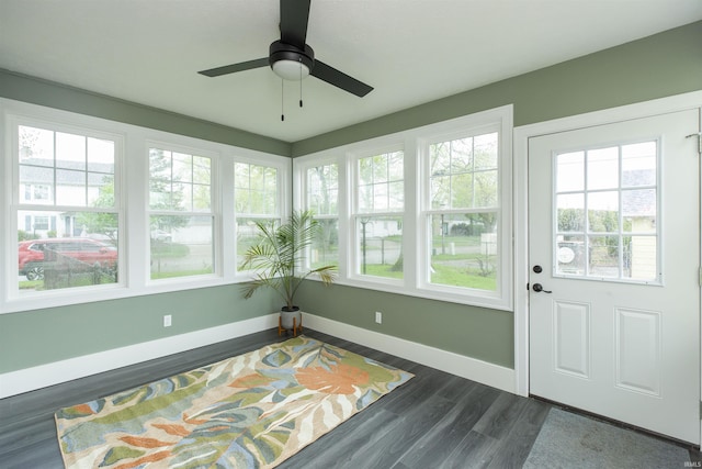sunroom with baseboards and wood finished floors