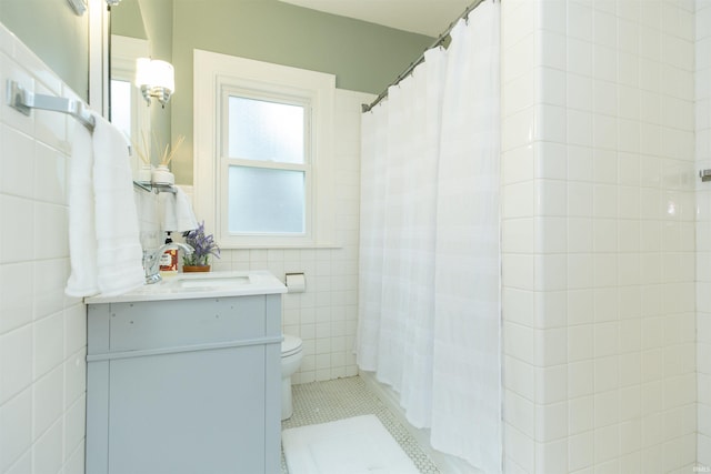 full bathroom featuring vanity, tile patterned flooring, toilet, tile walls, and a shower with shower curtain