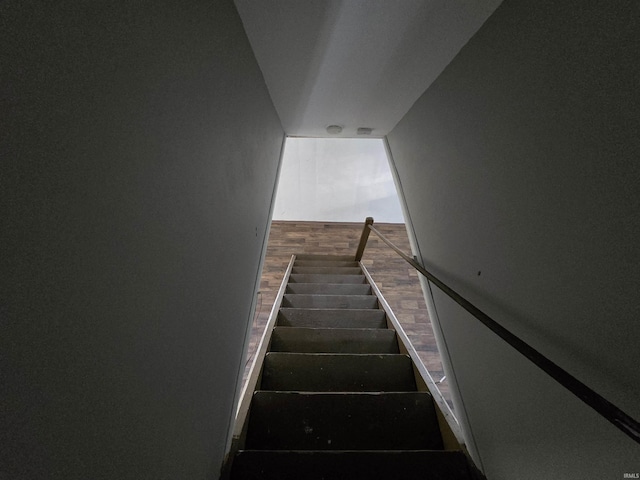 stairs featuring wood finished floors