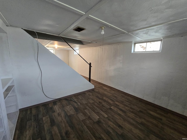 below grade area featuring visible vents and wood finished floors