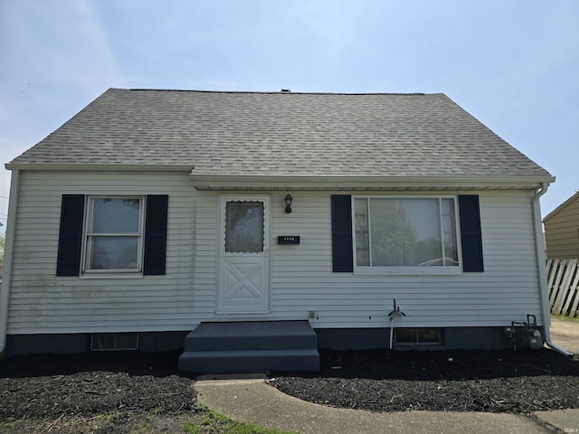view of front facade with roof with shingles