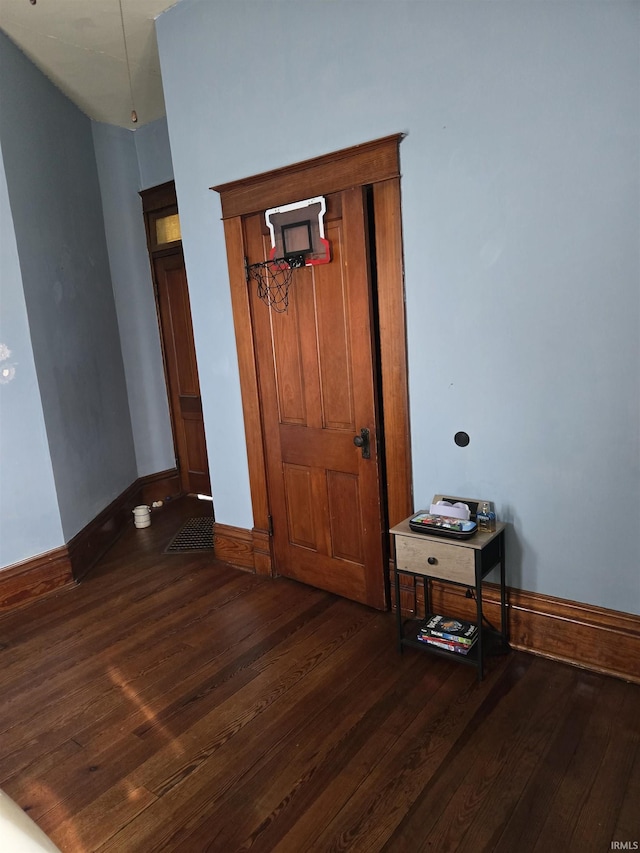 interior space featuring baseboards and wood finished floors