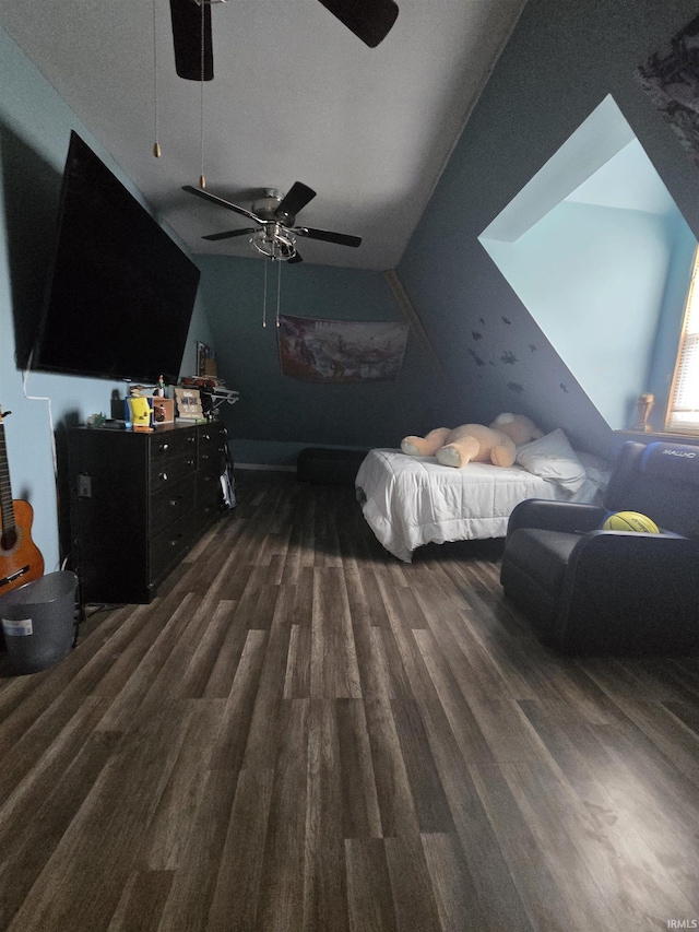 bedroom with a ceiling fan, wood finished floors, and lofted ceiling