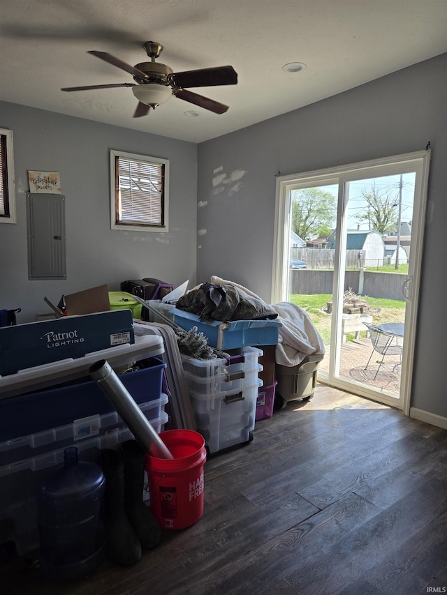 interior space featuring access to outside, ceiling fan, wood finished floors, and electric panel