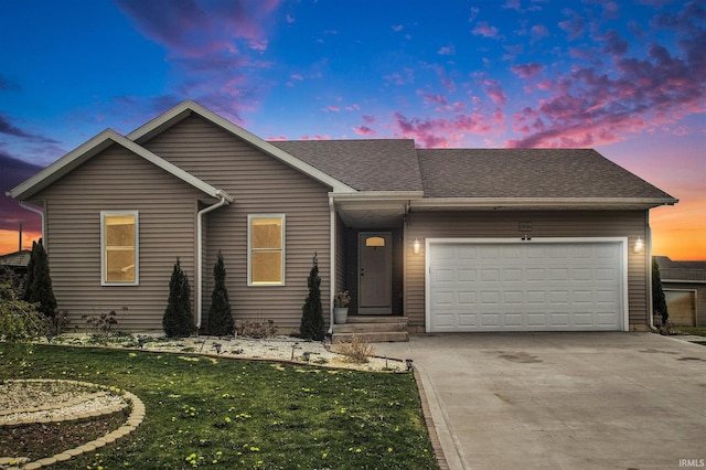 ranch-style house featuring a garage, a front lawn, driveway, and a shingled roof