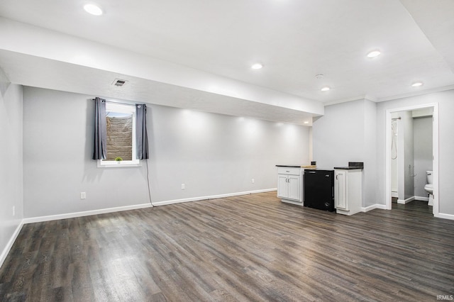 finished below grade area with dark wood-type flooring, recessed lighting, and baseboards