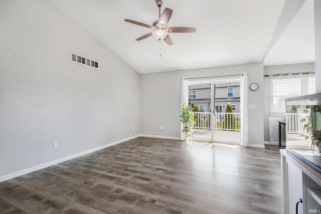 unfurnished living room with visible vents, baseboards, dark wood-type flooring, a ceiling fan, and vaulted ceiling