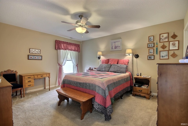 carpeted bedroom with baseboards and a ceiling fan