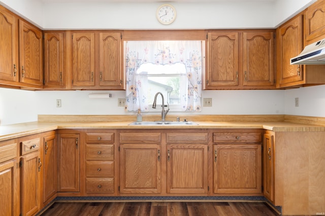 208 E Hickory Grove Rd, Hartford City, IN 47348 - kitchen with a sink, under cabinet range hood, brown cabinets, and light countertops