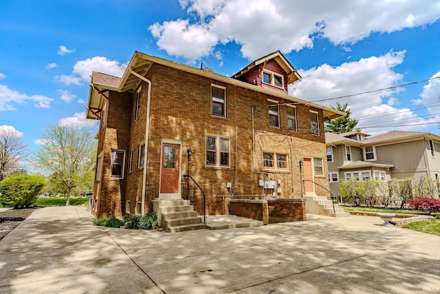 back of house with brick siding