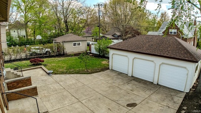 exterior space with an outdoor structure and a detached garage