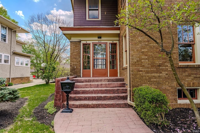 property entrance featuring brick siding