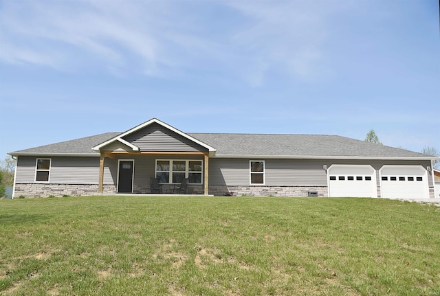 view of front of house with roof with shingles, an attached garage, a front lawn, and stone siding