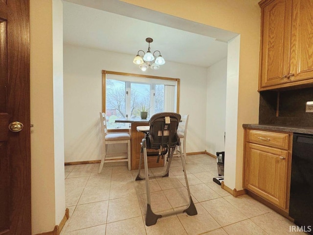dining room featuring an inviting chandelier, baseboards, and light tile patterned flooring