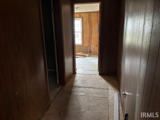 hall featuring wooden walls