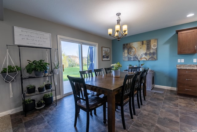dining room with baseboards and an inviting chandelier