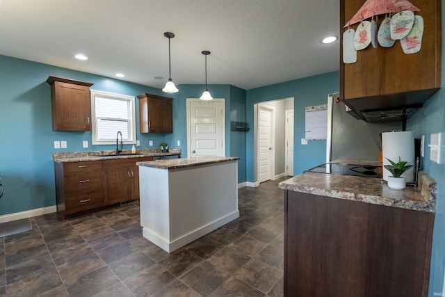 kitchen featuring a kitchen island, decorative light fixtures, a sink, baseboards, and recessed lighting