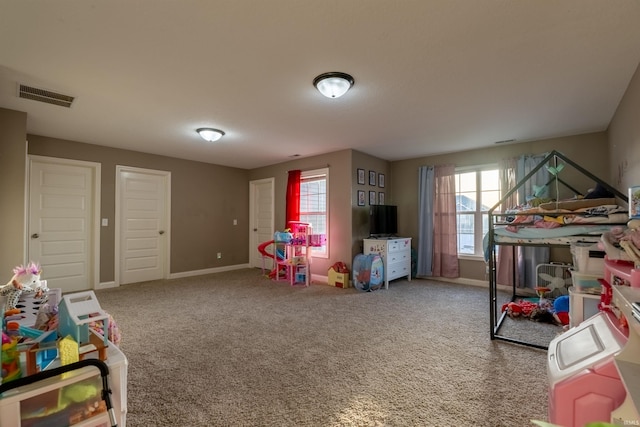 game room featuring baseboards, visible vents, and carpet