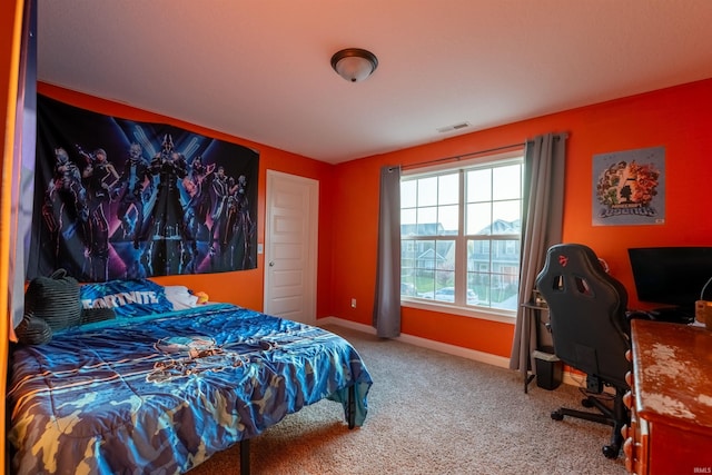 carpeted bedroom featuring visible vents and baseboards