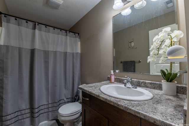 bathroom featuring vanity, a shower with shower curtain, visible vents, and toilet