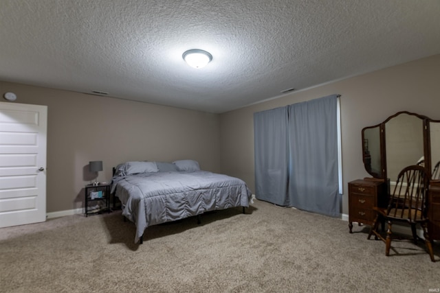bedroom featuring a textured ceiling and carpet