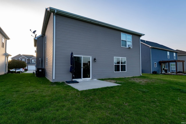 back of house with a yard and a patio area