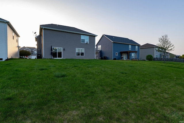 back of house with a lawn