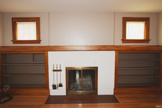 unfurnished living room with wood finished floors and a fireplace