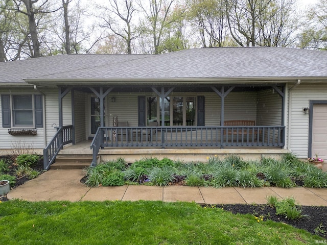 ranch-style home with a shingled roof and covered porch