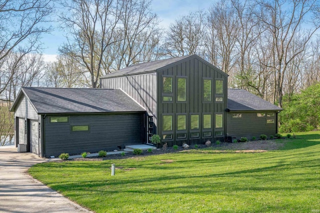 13440 N Summerhill Dr, Albany, IN 47320 - view of front of property featuring a garage, board and batten siding, a front yard, and a shingled roof