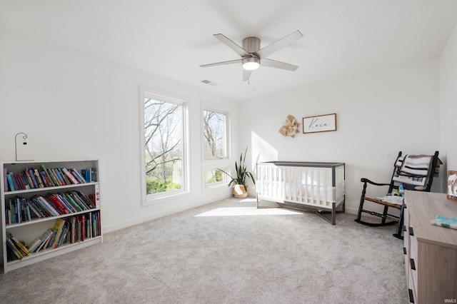 13440 N Summerhill Dr, Albany, IN 47320 - carpeted bedroom with a nursery area, baseboards, a ceiling fan, and visible vents