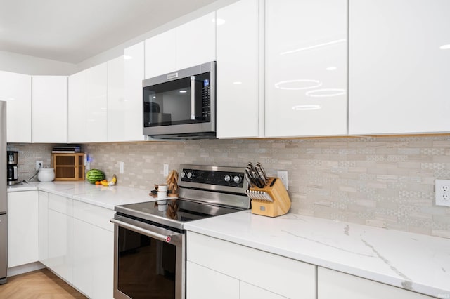 13440 N Summerhill Dr, Albany, IN 47320 - kitchen featuring white cabinets, stainless steel appliances, light stone counters, and decorative backsplash
