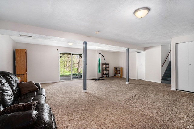 basement featuring carpet flooring, baseboards, visible vents, and stairs